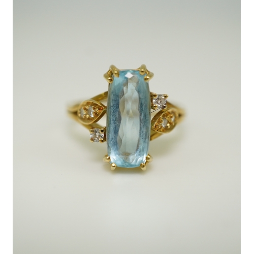 362 - An aquamarine and diamond ring, claw-set with an elongated cushion-shaped aquamarine measuring appro... 