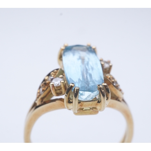 362 - An aquamarine and diamond ring, claw-set with an elongated cushion-shaped aquamarine measuring appro... 