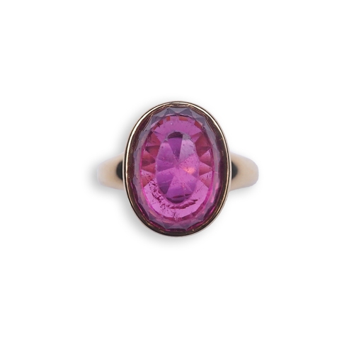 373 - Asprey, a pink tourmaline and diamond ring, set with an inverted oval pink tourmaline, the cup setti... 