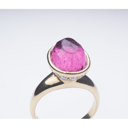 373 - Asprey, a pink tourmaline and diamond ring, set with an inverted oval pink tourmaline, the cup setti... 