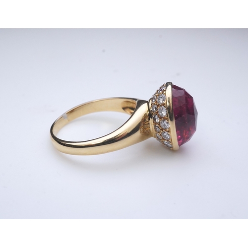 373 - Asprey, a pink tourmaline and diamond ring, set with an inverted oval pink tourmaline, the cup setti... 