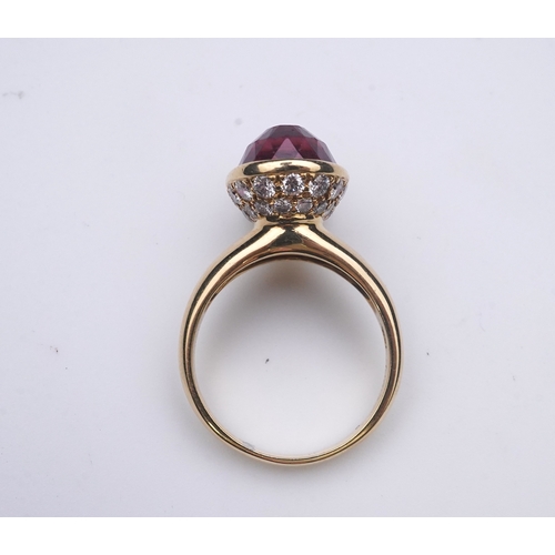 373 - Asprey, a pink tourmaline and diamond ring, set with an inverted oval pink tourmaline, the cup setti... 