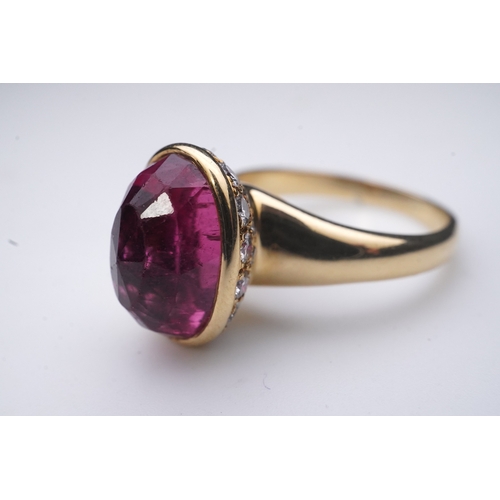 373 - Asprey, a pink tourmaline and diamond ring, set with an inverted oval pink tourmaline, the cup setti... 