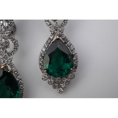 374 - A pair of synthetic green quartz and diamond earrings each of articulated pendent design, set with b... 