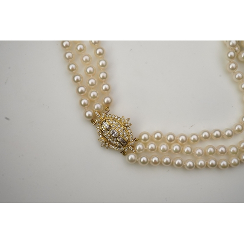 375 - A cultured pearl and diamond necklace/brooch, composed of three strands of cultured pearls, to a cla... 