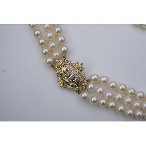 375 - A cultured pearl and diamond necklace/brooch, composed of three strands of cultured pearls, to a cla... 