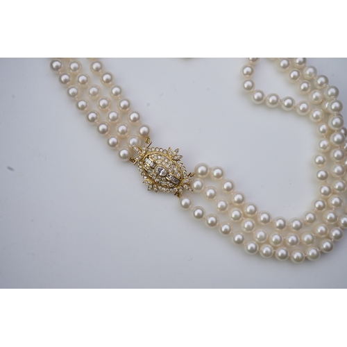 375 - A cultured pearl and diamond necklace/brooch, composed of three strands of cultured pearls, to a cla... 