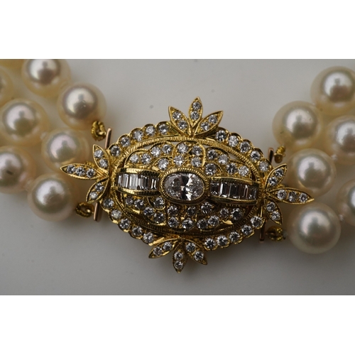 375 - A cultured pearl and diamond necklace/brooch, composed of three strands of cultured pearls, to a cla... 