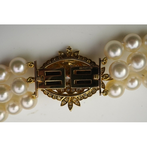 375 - A cultured pearl and diamond necklace/brooch, composed of three strands of cultured pearls, to a cla... 