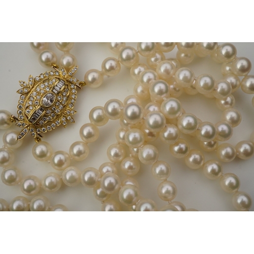 375 - A cultured pearl and diamond necklace/brooch, composed of three strands of cultured pearls, to a cla... 