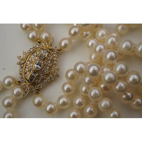 375 - A cultured pearl and diamond necklace/brooch, composed of three strands of cultured pearls, to a cla... 