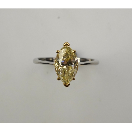 377 - A yellow diamond solitaire ring, claw-set with a marquise-shaped diamond of yellow tint weighing 2.0... 