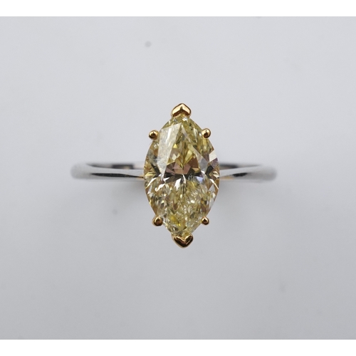 377 - A yellow diamond solitaire ring, claw-set with a marquise-shaped diamond of yellow tint weighing 2.0... 