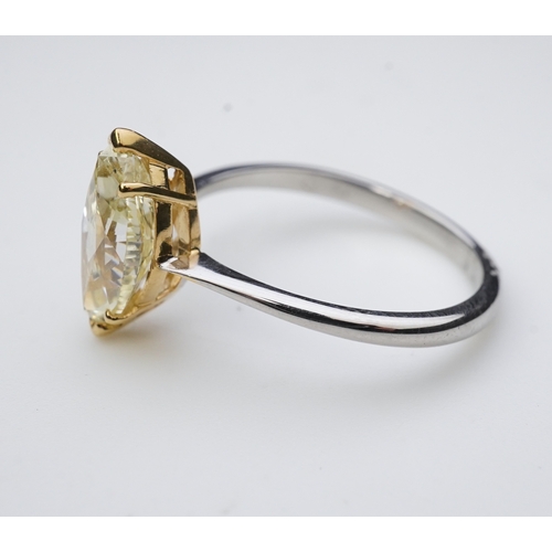 377 - A yellow diamond solitaire ring, claw-set with a marquise-shaped diamond of yellow tint weighing 2.0... 