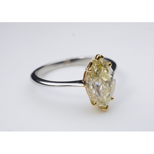 377 - A yellow diamond solitaire ring, claw-set with a marquise-shaped diamond of yellow tint weighing 2.0... 