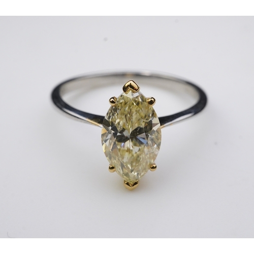 377 - A yellow diamond solitaire ring, claw-set with a marquise-shaped diamond of yellow tint weighing 2.0... 