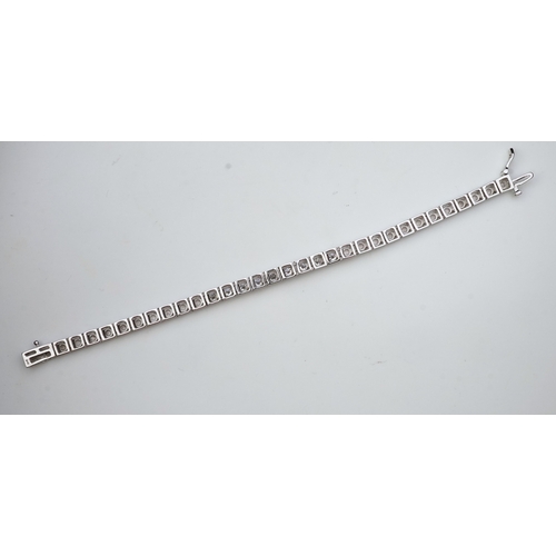 379 - A diamond line bracelet set to the centre with a line of brilliant-cut diamonds totalling approximat... 