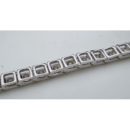 379 - A diamond line bracelet set to the centre with a line of brilliant-cut diamonds totalling approximat... 