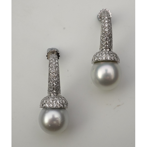 381 - A pair of South Sea cultured pearl and diamond earrings each designed as a half hoop, pavé-set with ... 