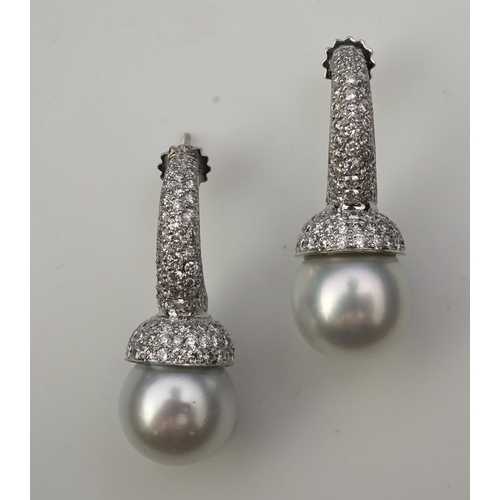 381 - A pair of South Sea cultured pearl and diamond earrings each designed as a half hoop, pavé-set with ... 