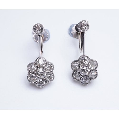 384 - A pair of diamond earrings, early 20th century each composed of a surmount suspending a floral clust... 