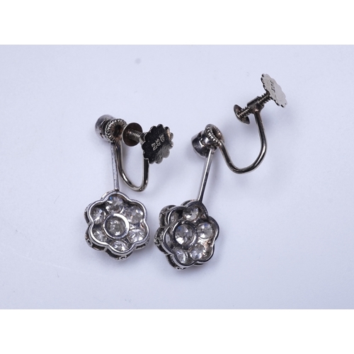 384 - A pair of diamond earrings, early 20th century each composed of a surmount suspending a floral clust... 