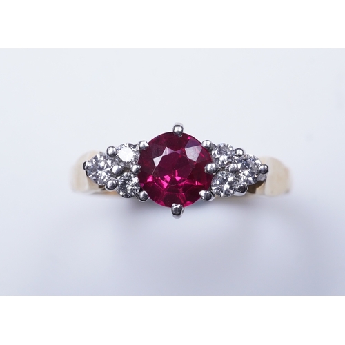 386 - A synthetic ruby and diamond ring, claw-set with a circular-cut synthetic ruby between shoulders set... 