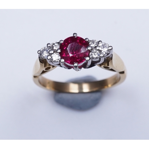 386 - A synthetic ruby and diamond ring, claw-set with a circular-cut synthetic ruby between shoulders set... 