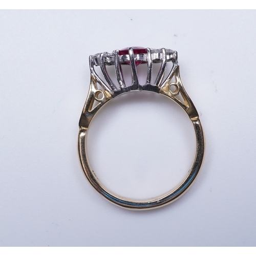 386 - A synthetic ruby and diamond ring, claw-set with a circular-cut synthetic ruby between shoulders set... 