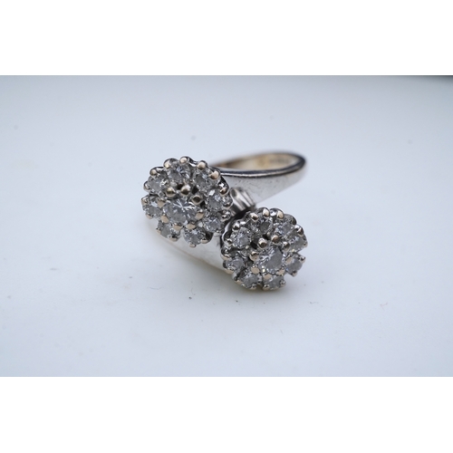 387 - A diamond 'toi et moi' ring, circa 1980 of crossover design, composed of two clusters of brilliant-c... 