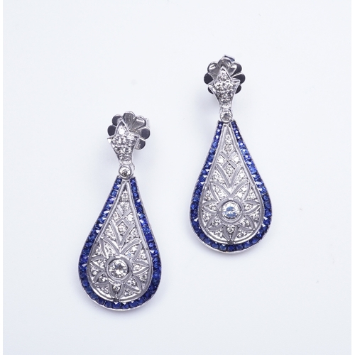 388 - A pair of sapphire and diamond earrings each designed in the Edwardian style, the foliate surmounts ... 