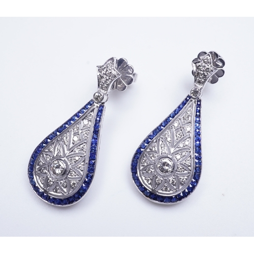 388 - A pair of sapphire and diamond earrings each designed in the Edwardian style, the foliate surmounts ... 