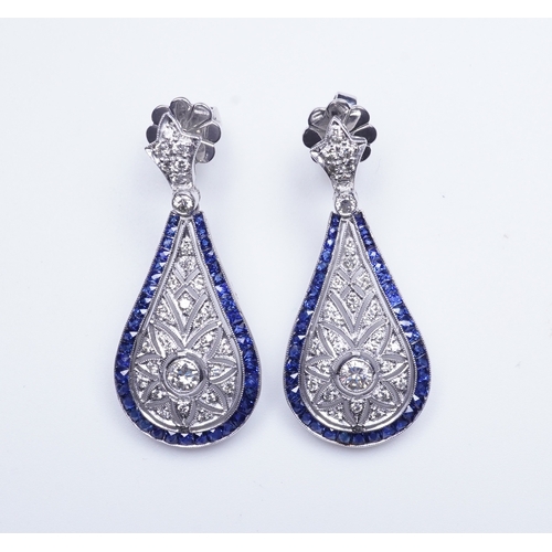 388 - A pair of sapphire and diamond earrings each designed in the Edwardian style, the foliate surmounts ... 