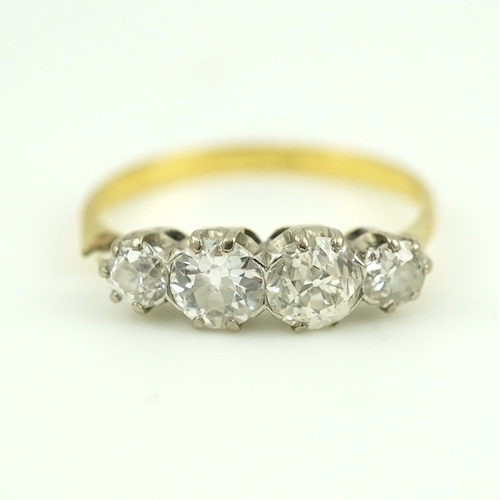 389 - A four-stone diamond ring, early 20th century, claw-set with four antique circular-cut diamonds tota... 