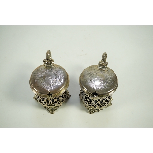 39 - A near pair of ornate Victorian pierced silver drum shaped mustard pots and covers, one by Charles T... 