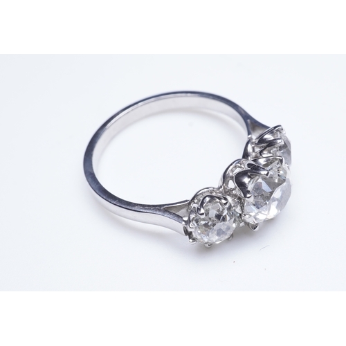 390 - A three-stone diamond ring, claw-set with three antique cushion-shaped diamonds totalling approximat... 