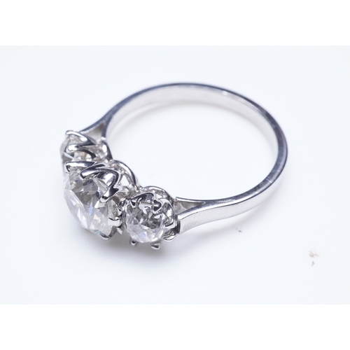 390 - A three-stone diamond ring, claw-set with three antique cushion-shaped diamonds totalling approximat... 