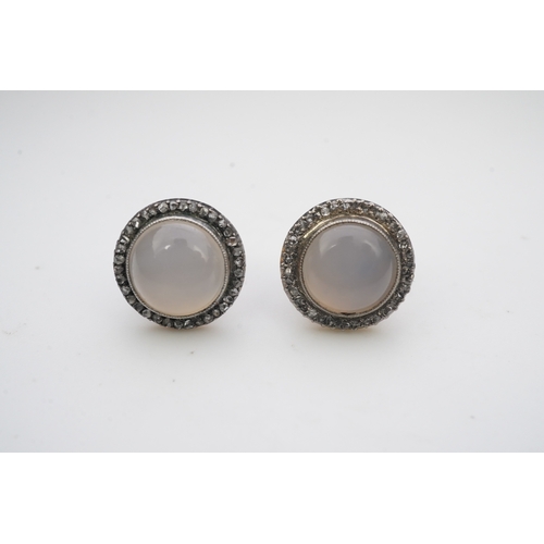 393 - A pair of chalcedony and diamond earrings, each of cluster design, millegrain-set with a cabochon of... 