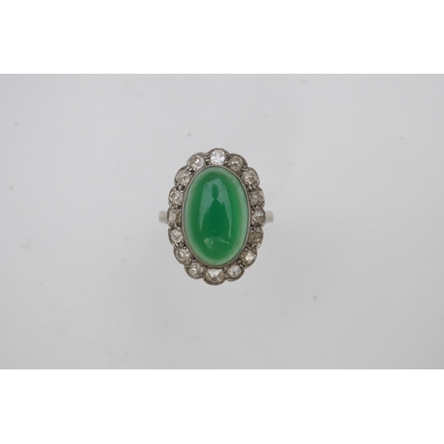 395 - A green chalcedony and diamond ring, early 20th century, of cluster design, set with an oval green c... 