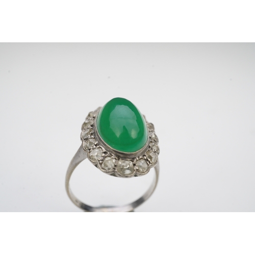 395 - A green chalcedony and diamond ring, early 20th century, of cluster design, set with an oval green c... 