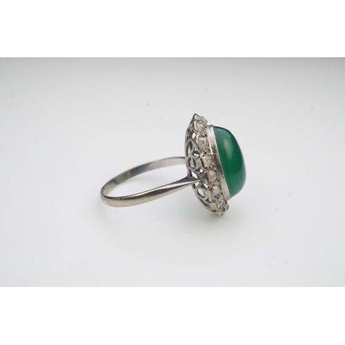 395 - A green chalcedony and diamond ring, early 20th century, of cluster design, set with an oval green c... 