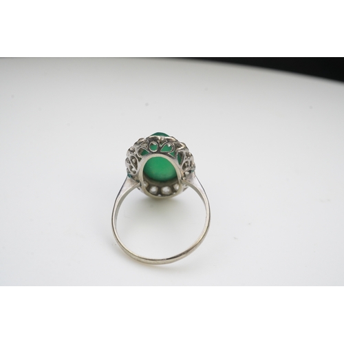 395 - A green chalcedony and diamond ring, early 20th century, of cluster design, set with an oval green c... 