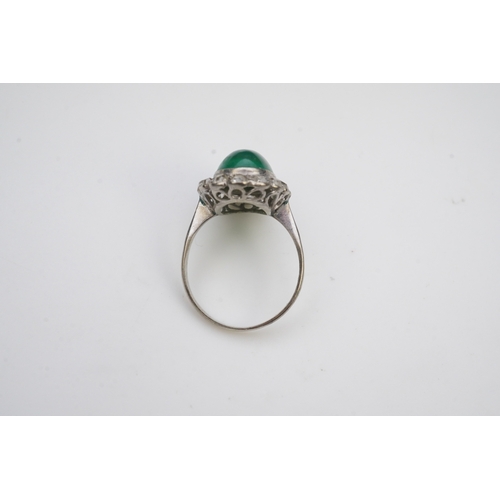 395 - A green chalcedony and diamond ring, early 20th century, of cluster design, set with an oval green c... 