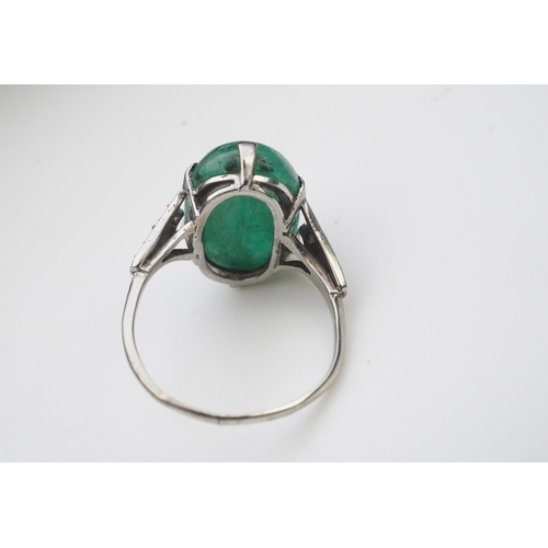 397 - An emerald and diamond ring, early 20th century, claw-set with a cabochon emerald, to shoulders mill... 