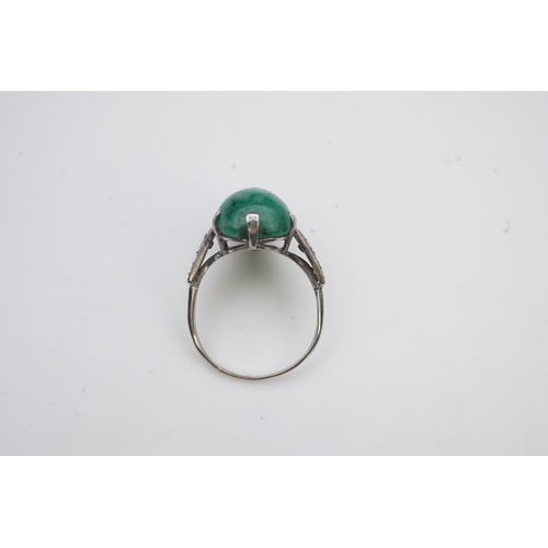 397 - An emerald and diamond ring, early 20th century, claw-set with a cabochon emerald, to shoulders mill... 