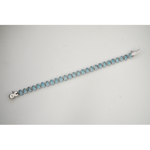 398 - A blue topaz bracelet, designed as an articulated line of oval blue topazes, mounted in silver, leng... 