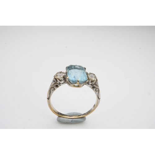 399 - An aquamarine and diamond ring, early 20th century, claw-set with a cushion-shaped aquamarine betwee... 