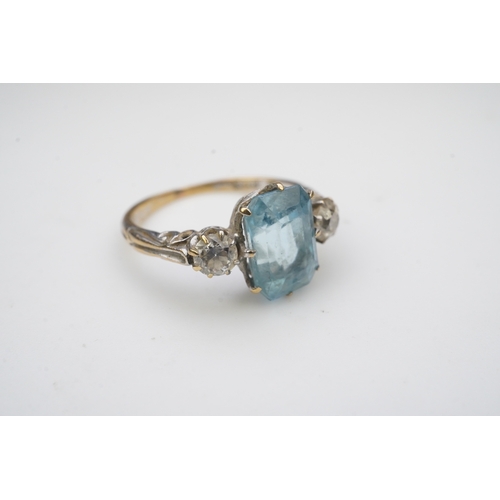 399 - An aquamarine and diamond ring, early 20th century, claw-set with a cushion-shaped aquamarine betwee... 