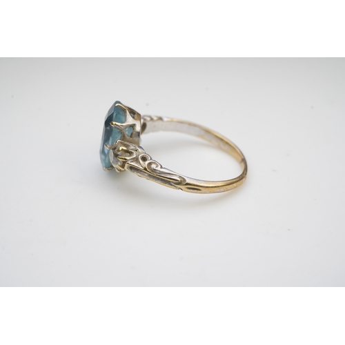 399 - An aquamarine and diamond ring, early 20th century, claw-set with a cushion-shaped aquamarine betwee... 