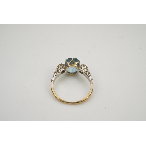 399 - An aquamarine and diamond ring, early 20th century, claw-set with a cushion-shaped aquamarine betwee... 